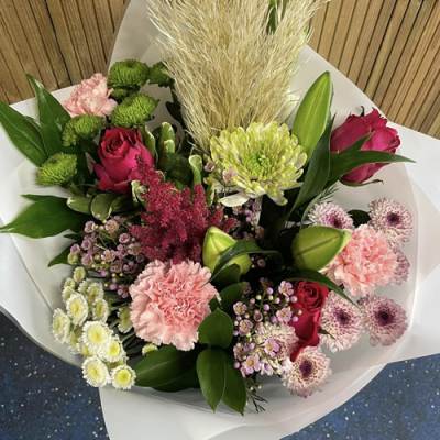 English Garden - A stunning handtied created using pale pink, red and white flowers with complimentary foliage. Hand delivered with care in and around Newcastle by Fantasia Florist.