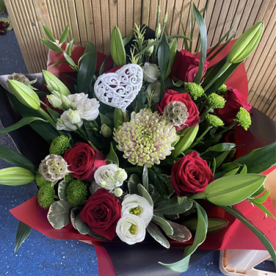 Head Over Heels - A beautiful handtied bouquet in water presented in a gift box/bag. Created using red roses and white flowers with complimentary foliage. Hand delivered with care in and around Newcastle by Fantasia Florist.